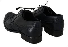 Dolce & Gabbana Dunkelblaue Oxford-Slipper mit Flügelkappen aus Leder