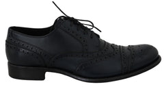 Dolce & Gabbana Dunkelblaue Oxford-Slipper mit Flügelkappen aus Leder