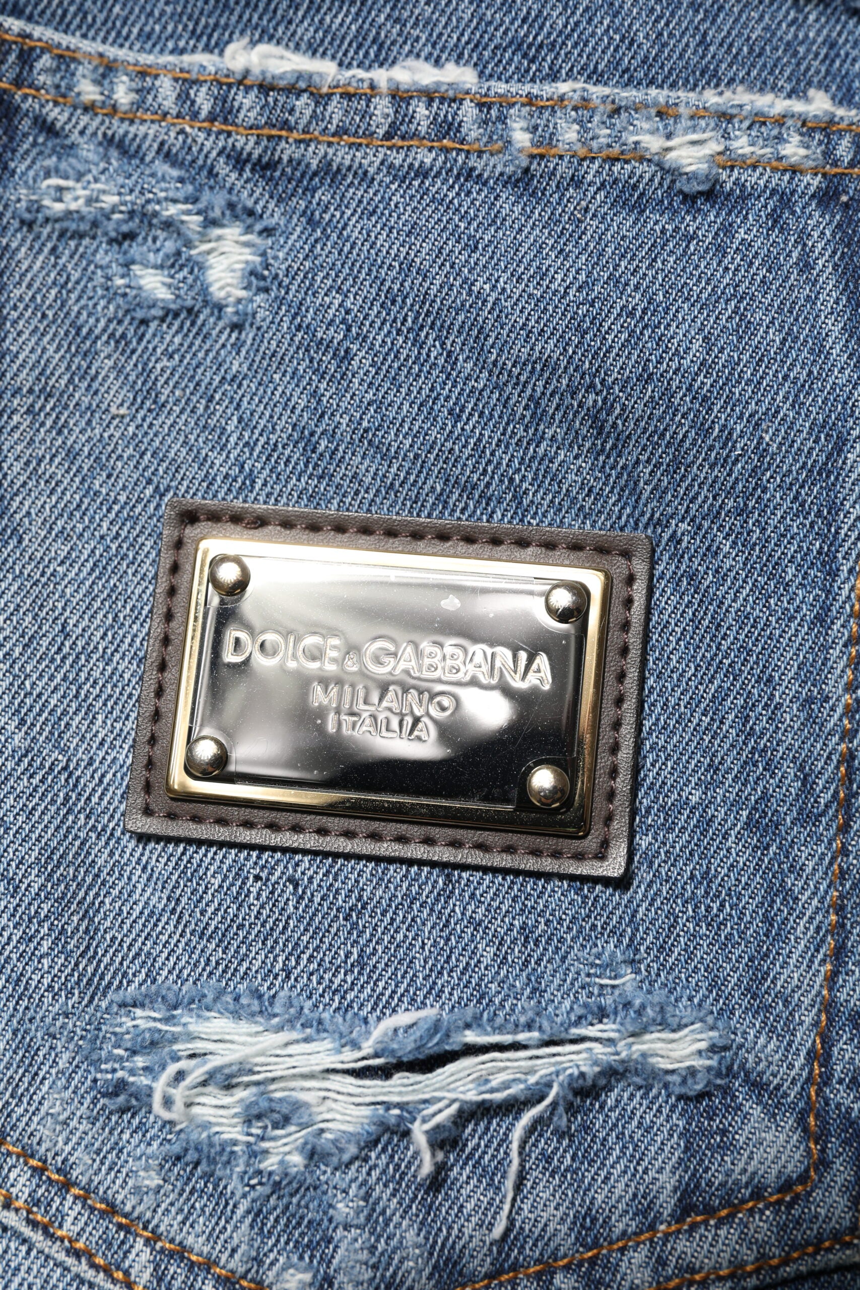 Dolce & Gabbana Blaue zerrissene Jeans aus Baumwolle mit Logo-Plakette