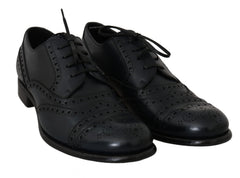 Dolce & Gabbana Dunkelblaue Oxford-Slipper mit Flügelkappen aus Leder